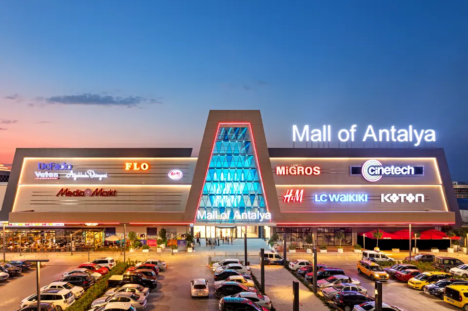 Best Shopping Malls in Antalya – Entrance of Mall of Antalya at night with colorful lights