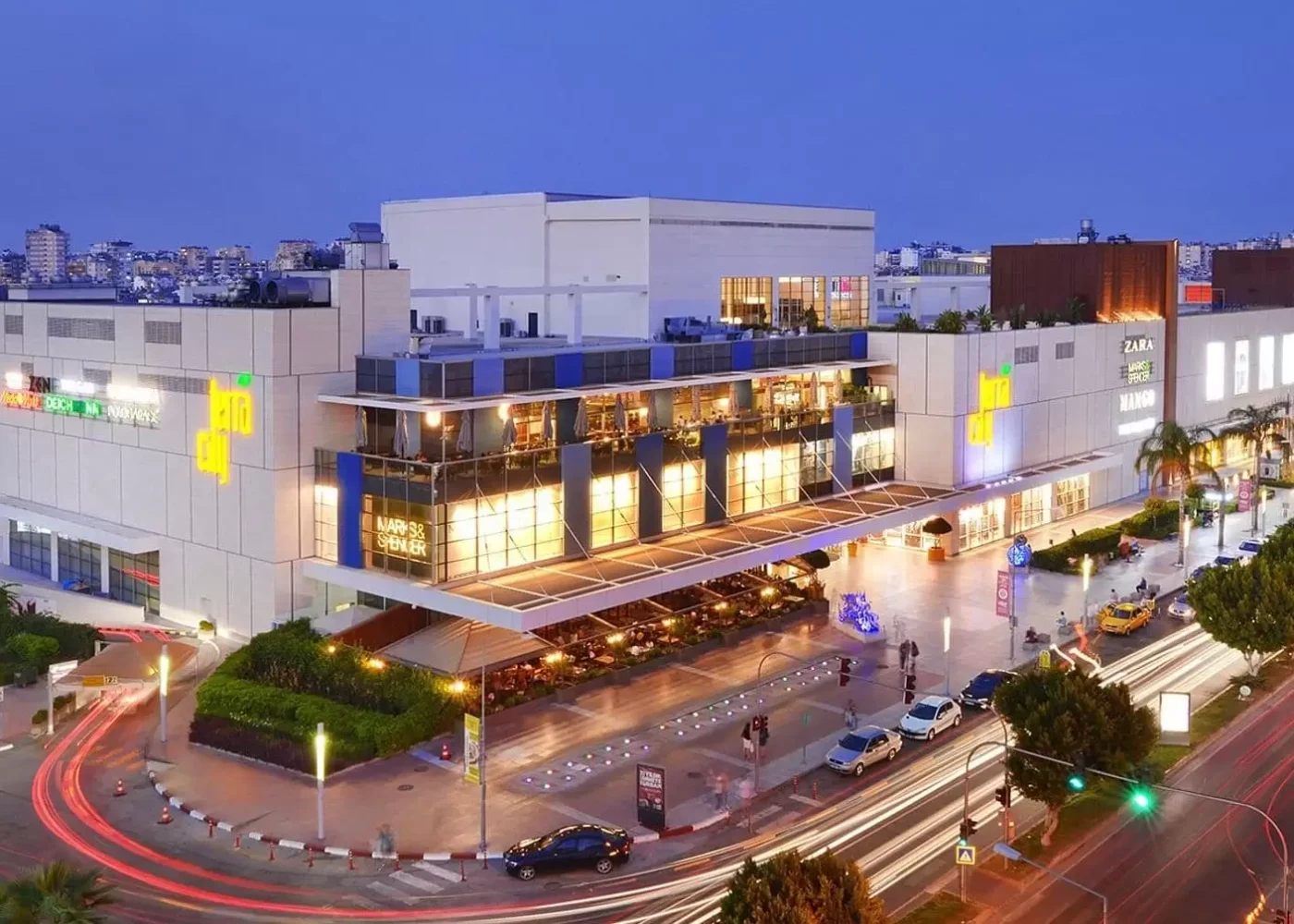 Terracity Shopping Center at dusk with luxury storefronts and stylish outdoor lighting in Lara, Antalya